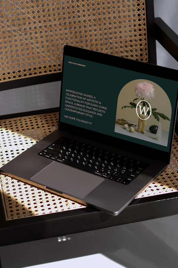 interior design branding on a laptop on a chair reflecting a contemporary yet romantic style in the interior design world