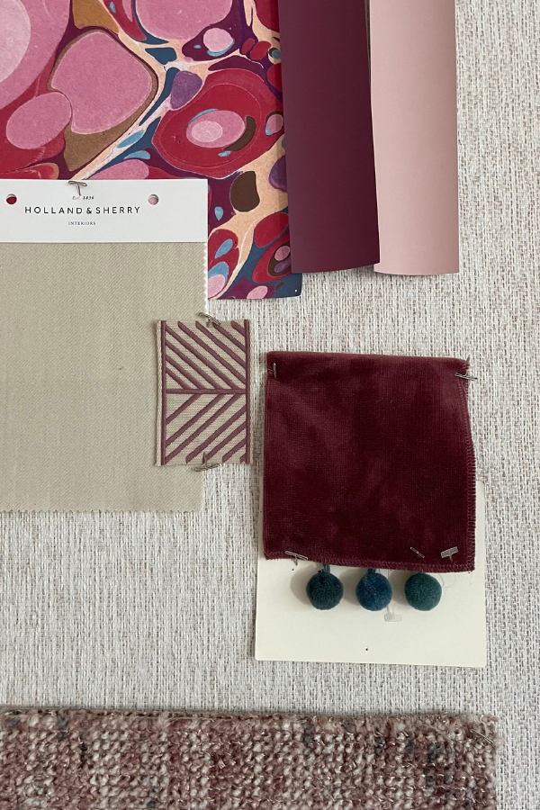 a mood board showing interior design branding and fabric samples in shades of pink and red