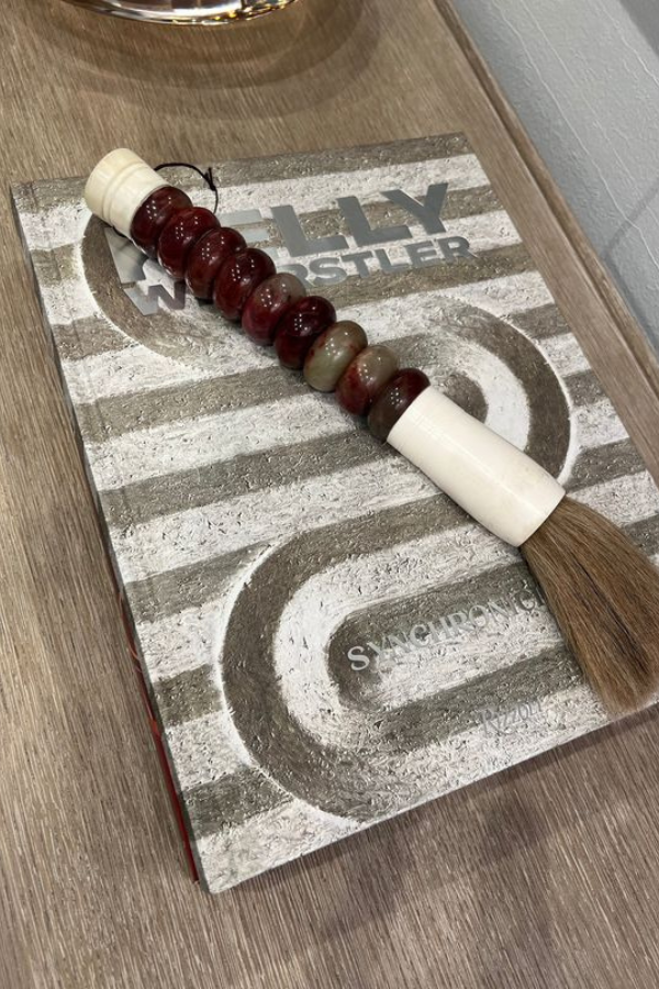 The cover of a Kelly Wearstler book on a sideboard