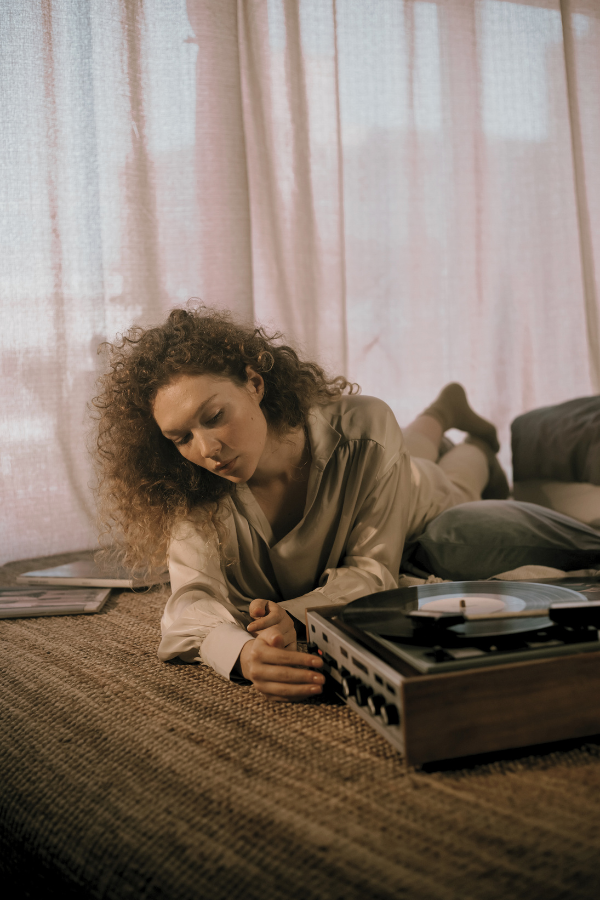 woman listening to records on the floor, one of many retro social activities