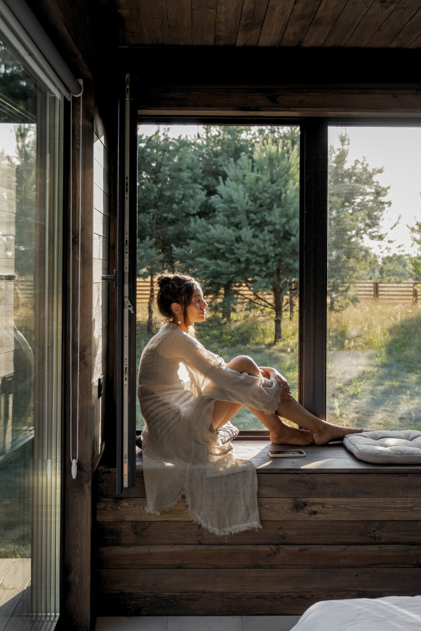 woman in a window seat preparing for a digital detox