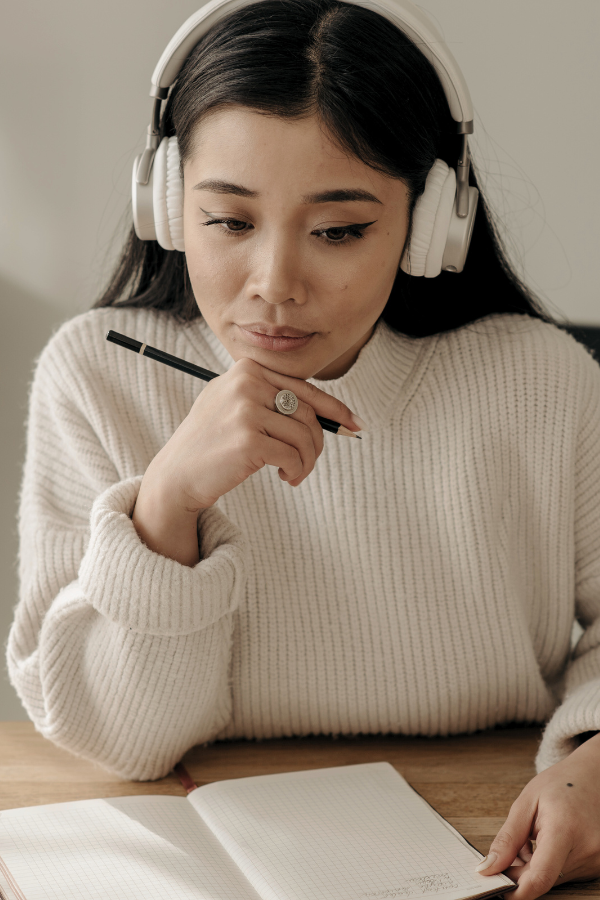 this woman wearing headphones is studying for the california real estate exam