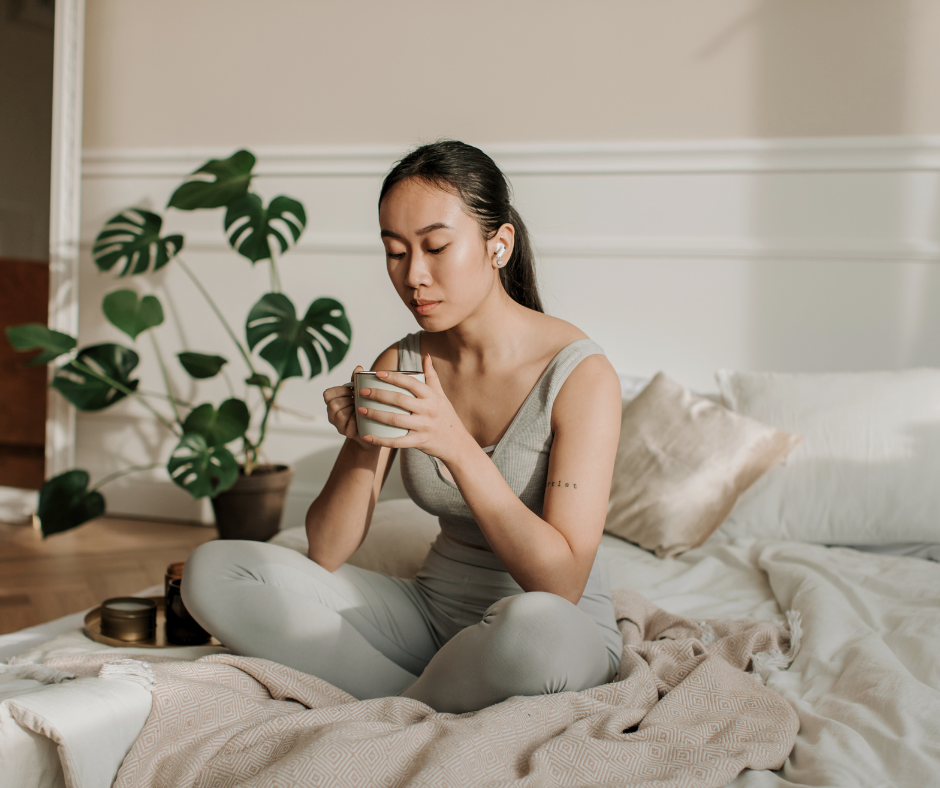 Endometriosis Awareness Month: woman sits on her bed with a cup of tea