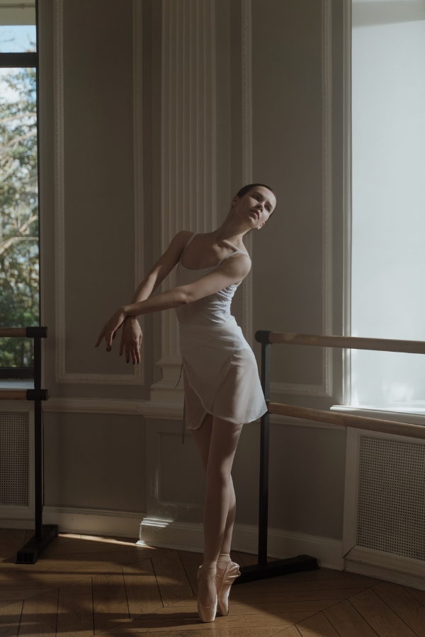 prima ballerina dancing indoors