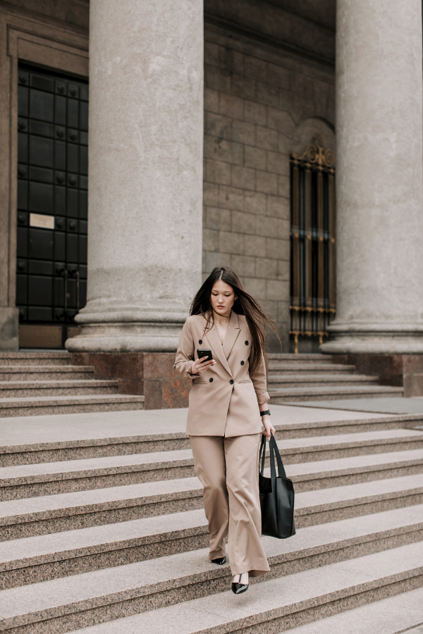 the Best Books for Realtors like this professional woman walking down the steps in a beige suit