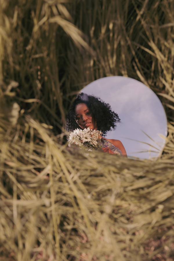 woman in a mirror in a field