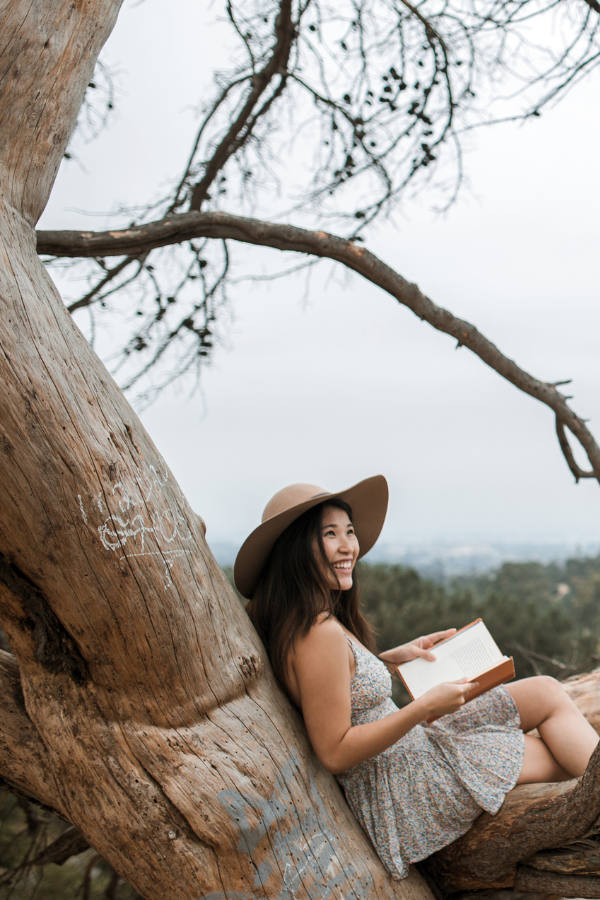 woman sitting in a tree learning how to become a book scout