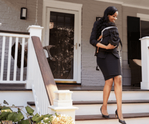 female real estate agent carrying her baby from a house