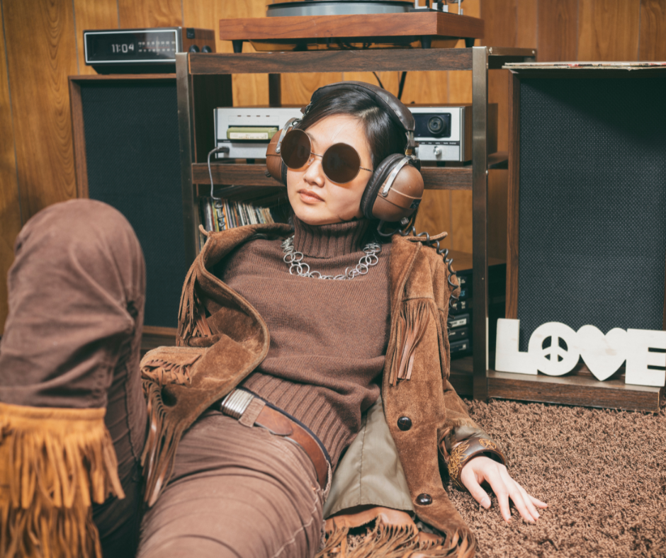 woman in a room with very 70s interior design listening to a sound system wearing vintage headphones