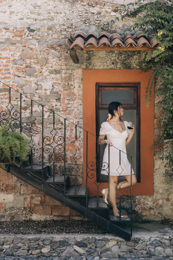 woman drinking a red summer wine on a step