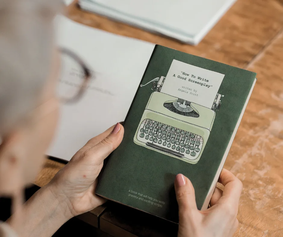 woman holding a screenwriting book preparing to take screenwriting workshops