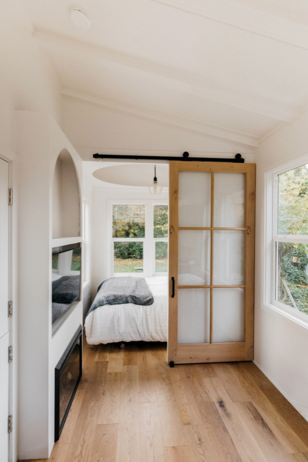 a tiny house design with the bedroom and built-ins visible