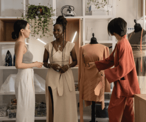 three women meeting in a fashion fitting studio