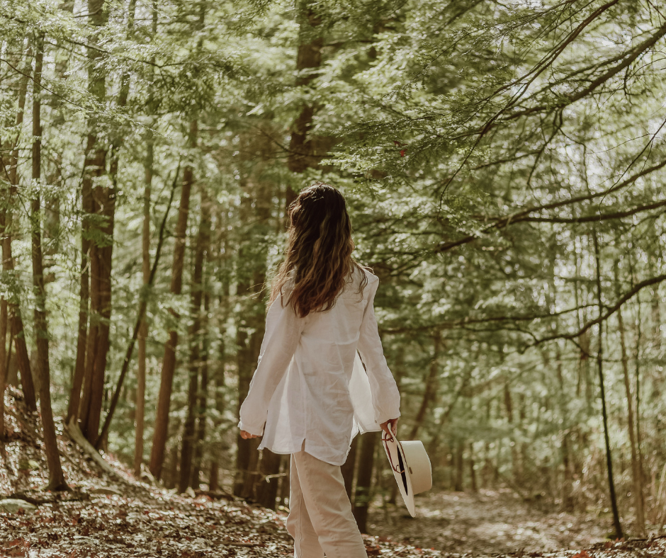 Woman on a walking Zazen meditation through the forest
