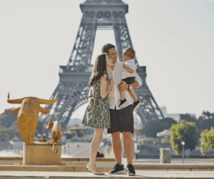 parents in Paris with kids in front of the Eiffel Tower