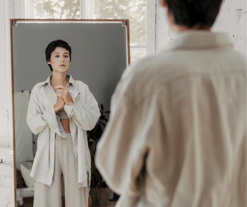 woman looking in a mirror, similar to what would happen in an AR virtual styling session