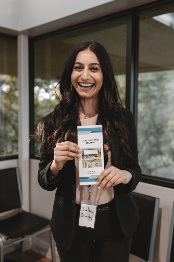 a woman holding a brochure for her elevator pitch