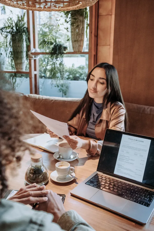 a woman reading a resume in a coffee shop