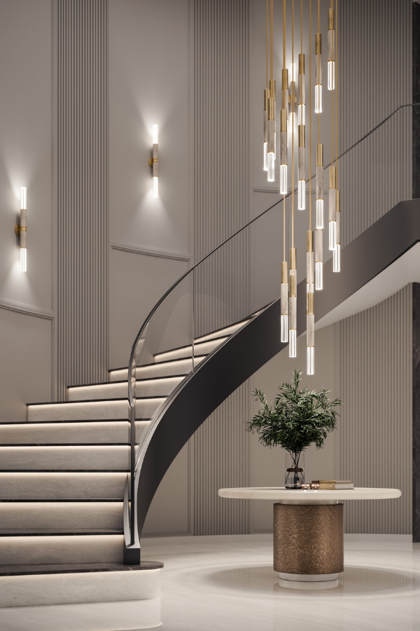 Modern interior featuring a curved floating staircase, sculptural pendant lighting, fluted wall paneling, and a minimalist entry table in a luxury home. The furniture and lighting is from JIMECO.