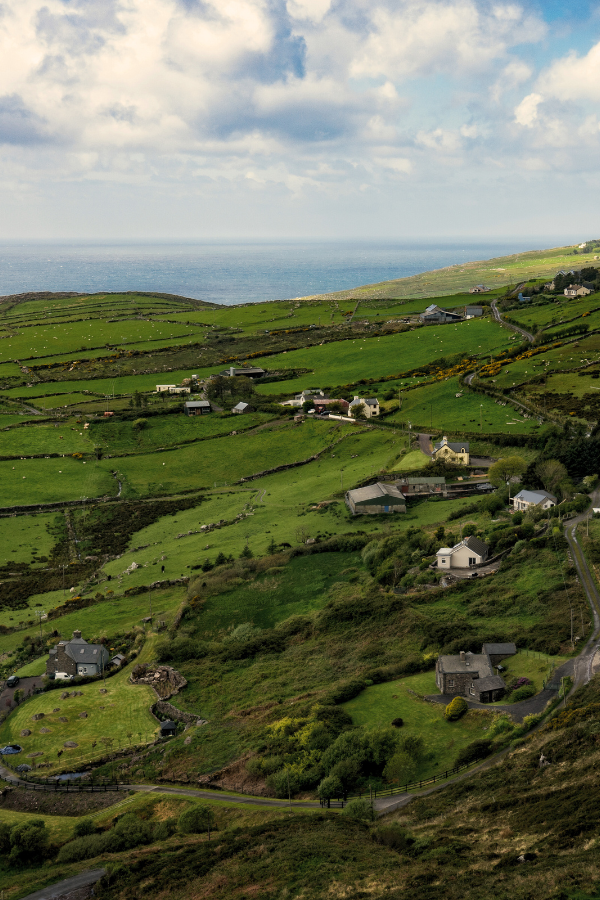 the Irish countryside with green hills and small houses