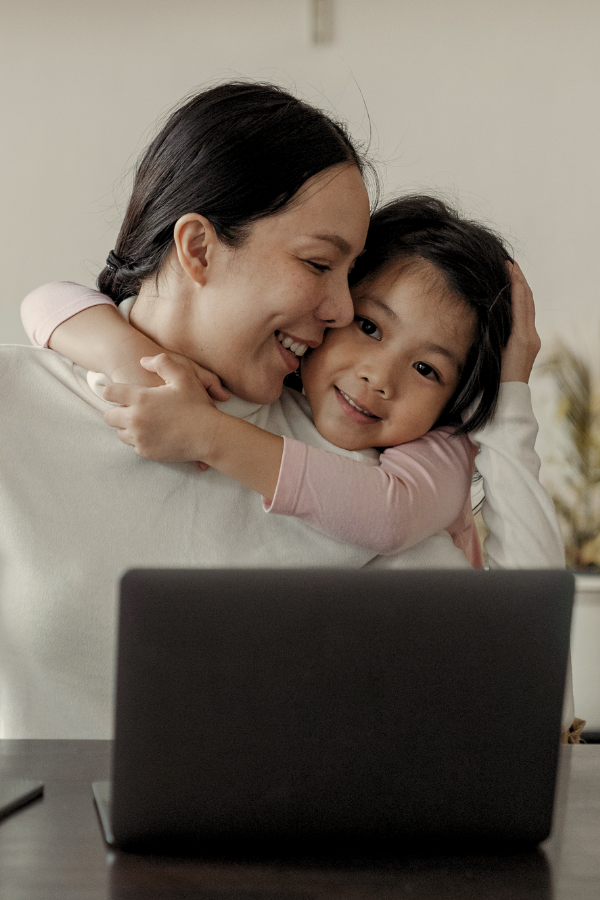 a woman working with her daughter behind her