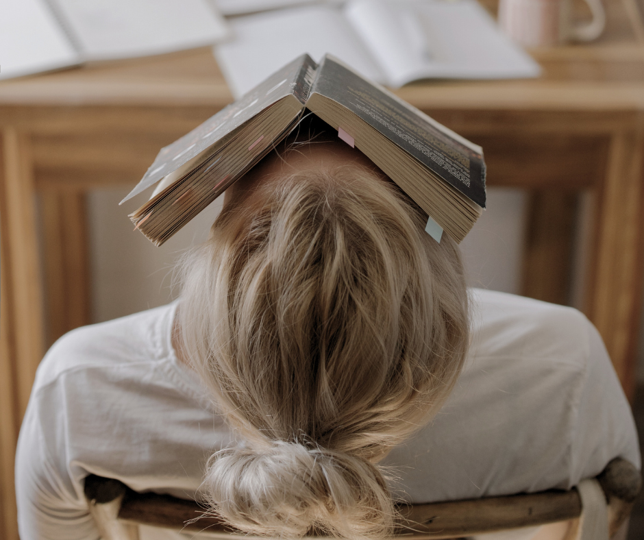 a woman with an open book on her face