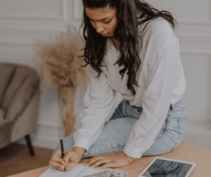 a woman budgeting while sitting on her desk