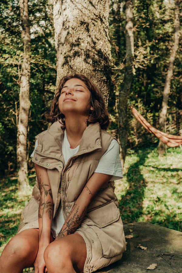 woman sitting in the forest