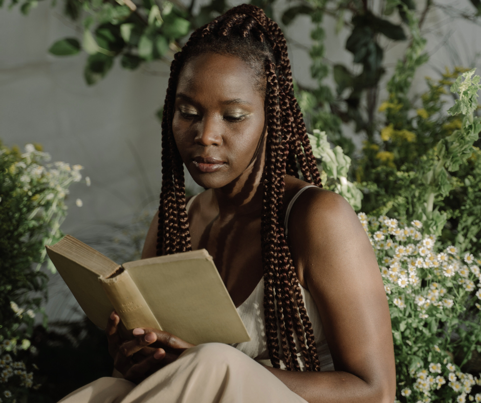 woman reading a book surrounded by plants