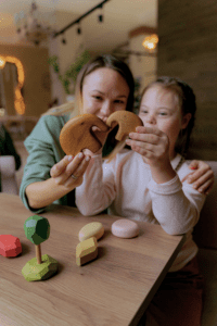 a mom and daughter playing with wooden toys