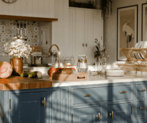 blue and white kitchen with flowers on the counter