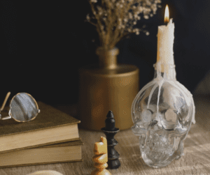 Halloween decorations with a skull candle and chess pieces