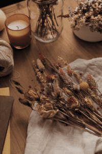 a vignette of fall candles and dried flowers