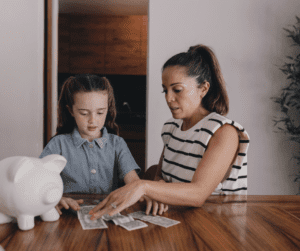 a mom and her daughter counting money