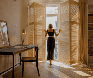 a woman standing in front of a window