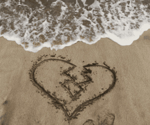 a broken heart on the beach after a friendship breakup