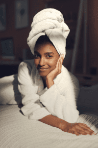 a woman lays on the bed relaxing