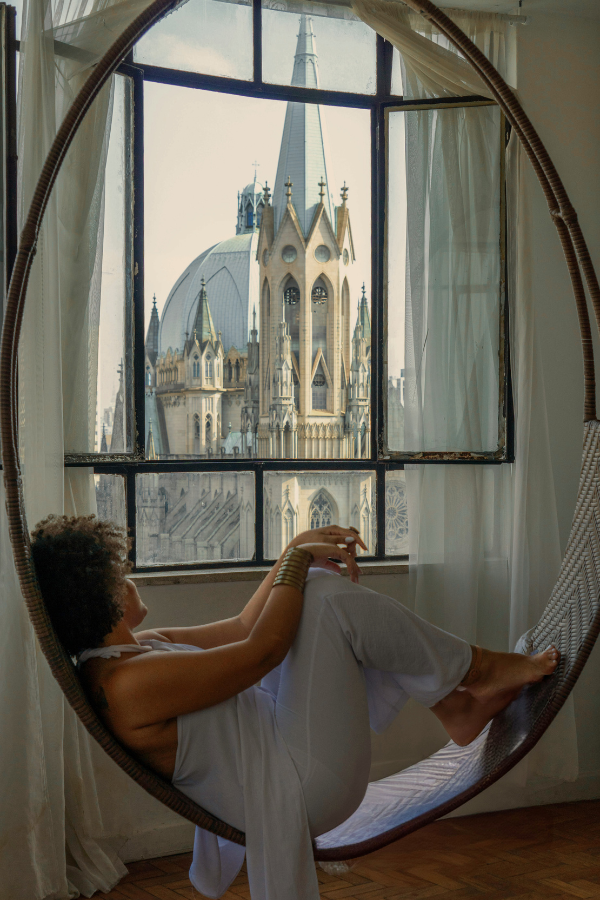 a woman rests in a window chair