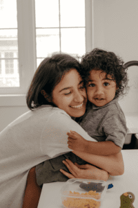 a mom holds her toddler