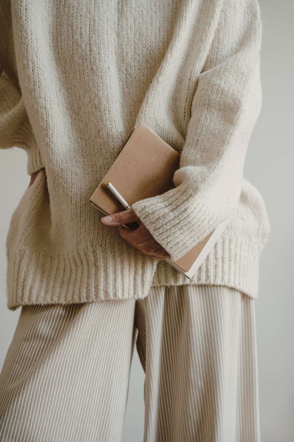 woman in a sweater outfit preparing for taxes