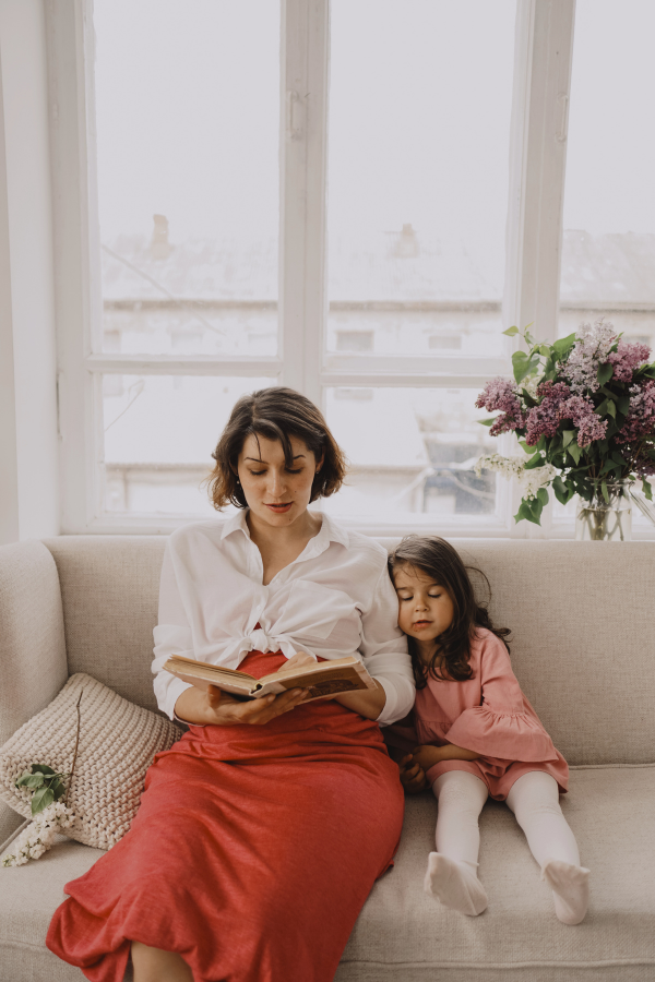 an introverted parent reads to her daughter