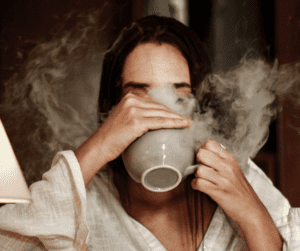 a woman drinking tea as part of her winter wellness routine