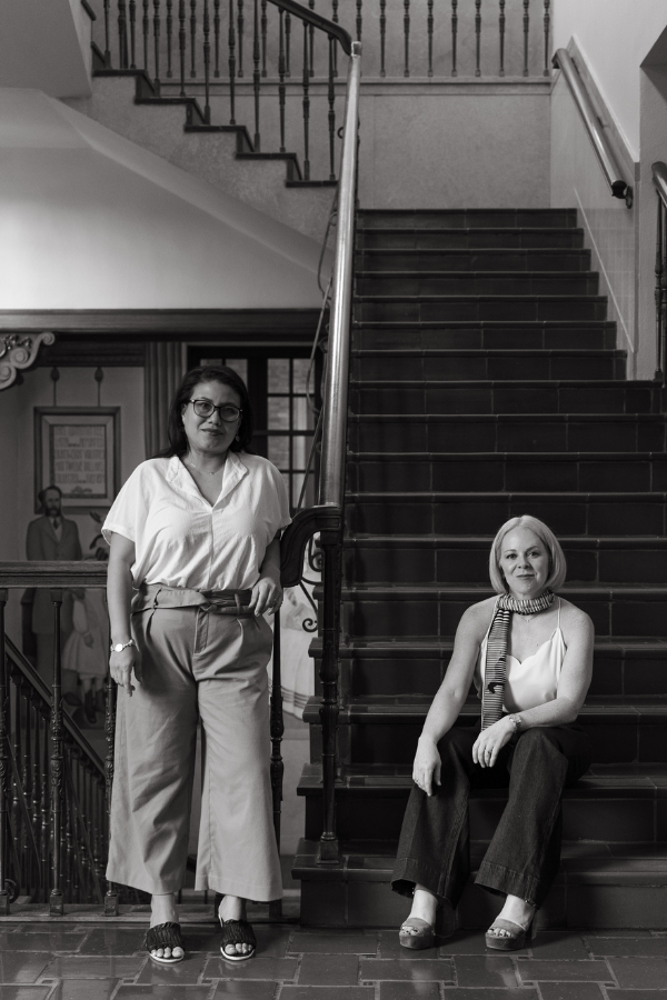 laura and melissa sit in a historic building