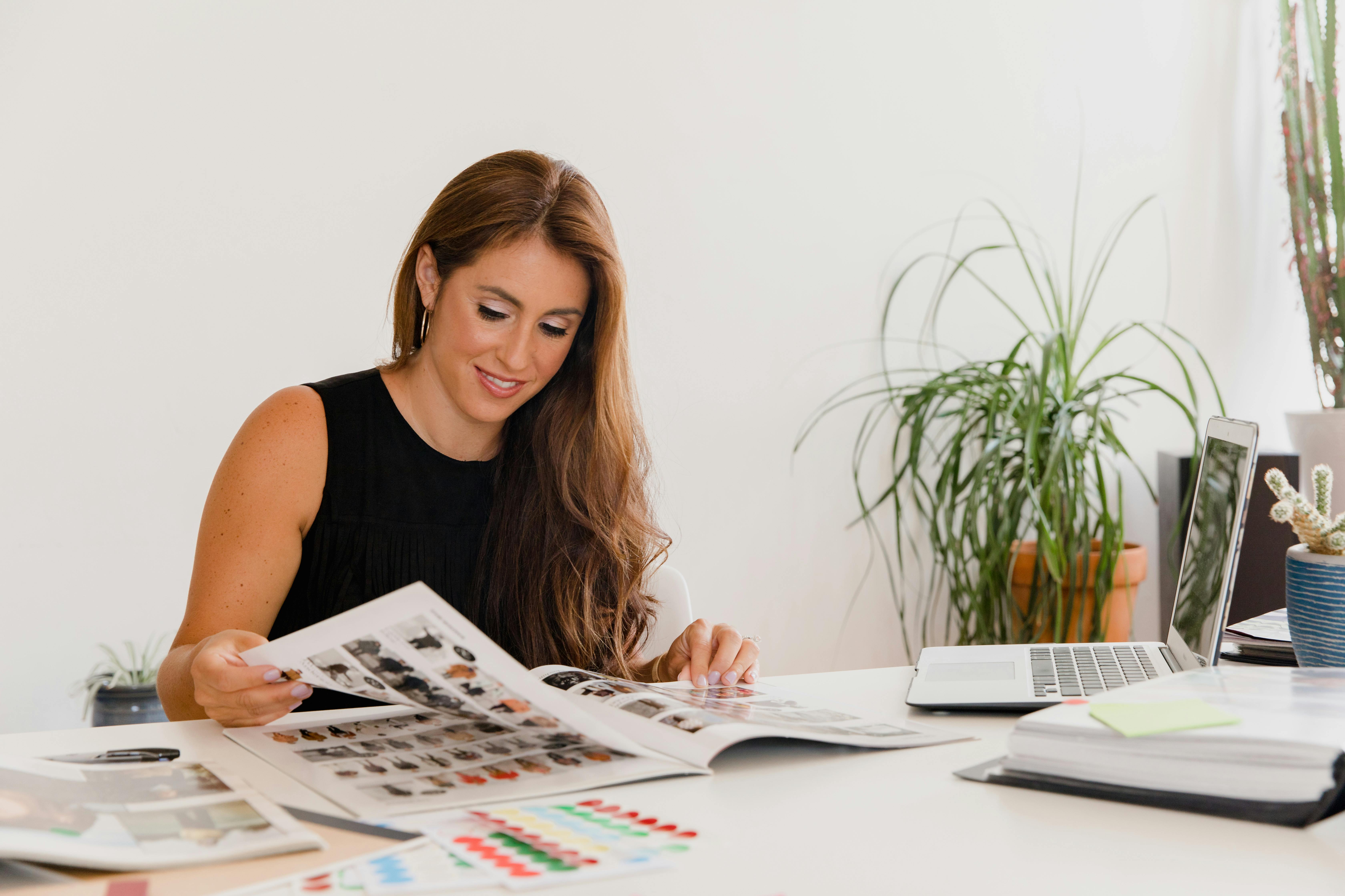 A woman looking at design materials on a table.