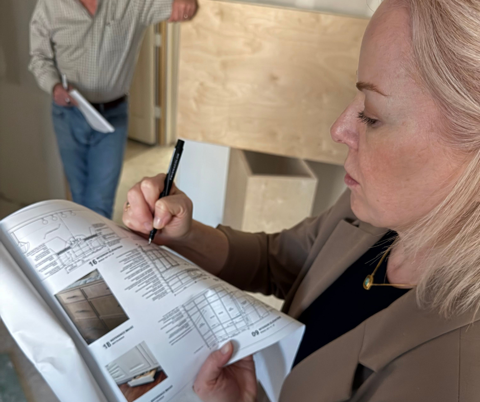 Laura holding a booklet of change orders