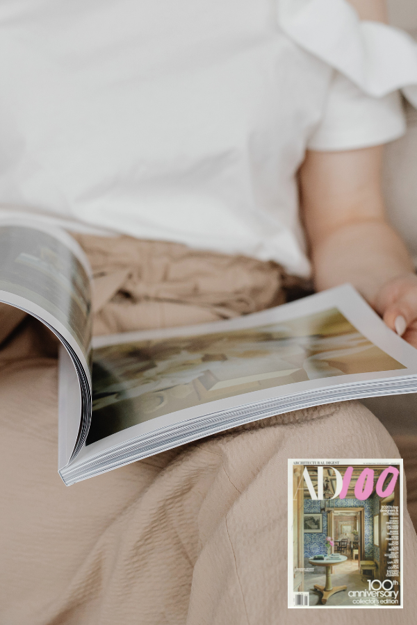 a woman reading a magazine that could be Architectural Digest