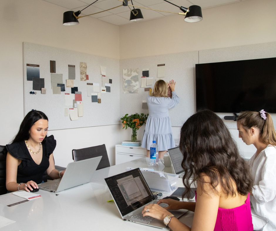 interior designers gathering around computers