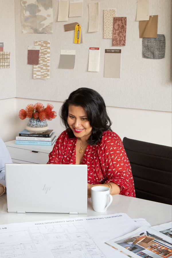 DesignDash community member works on her computer in design firm studio