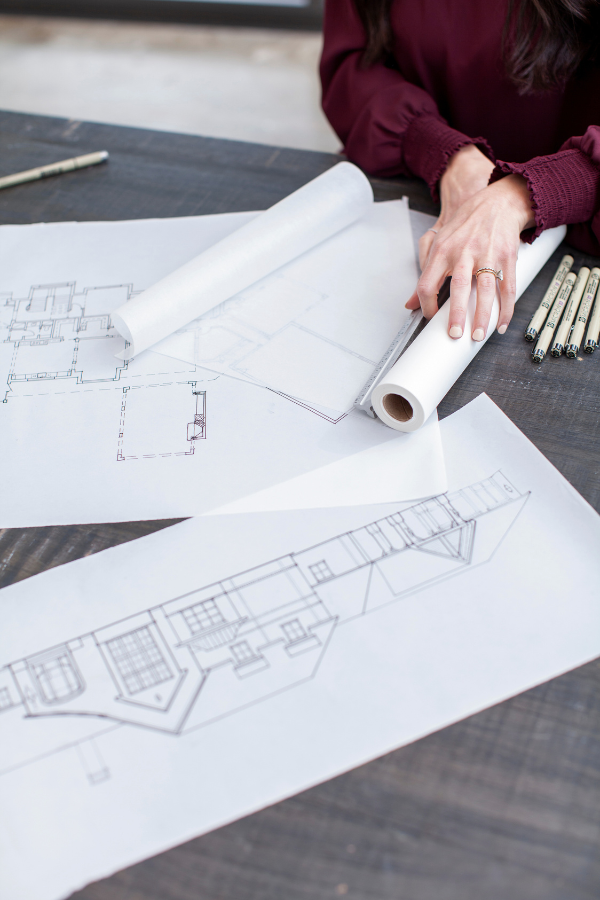 a designer rolling out plans
