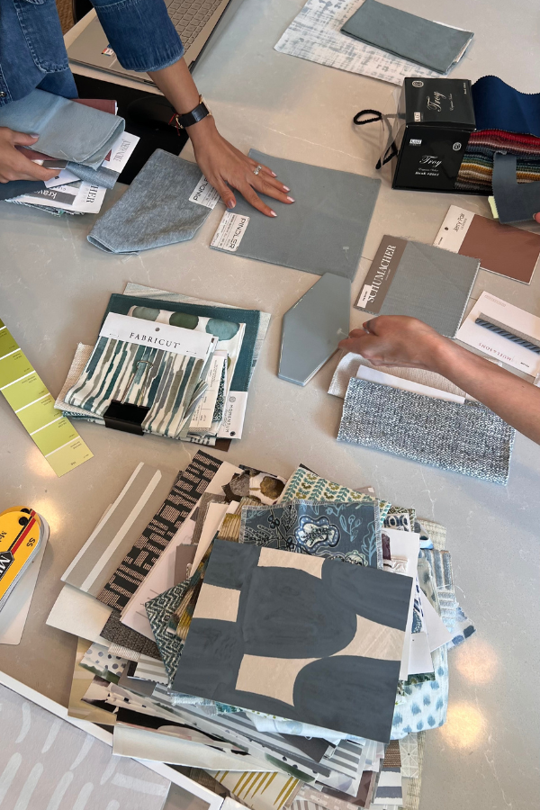 two interior designers sift through samples